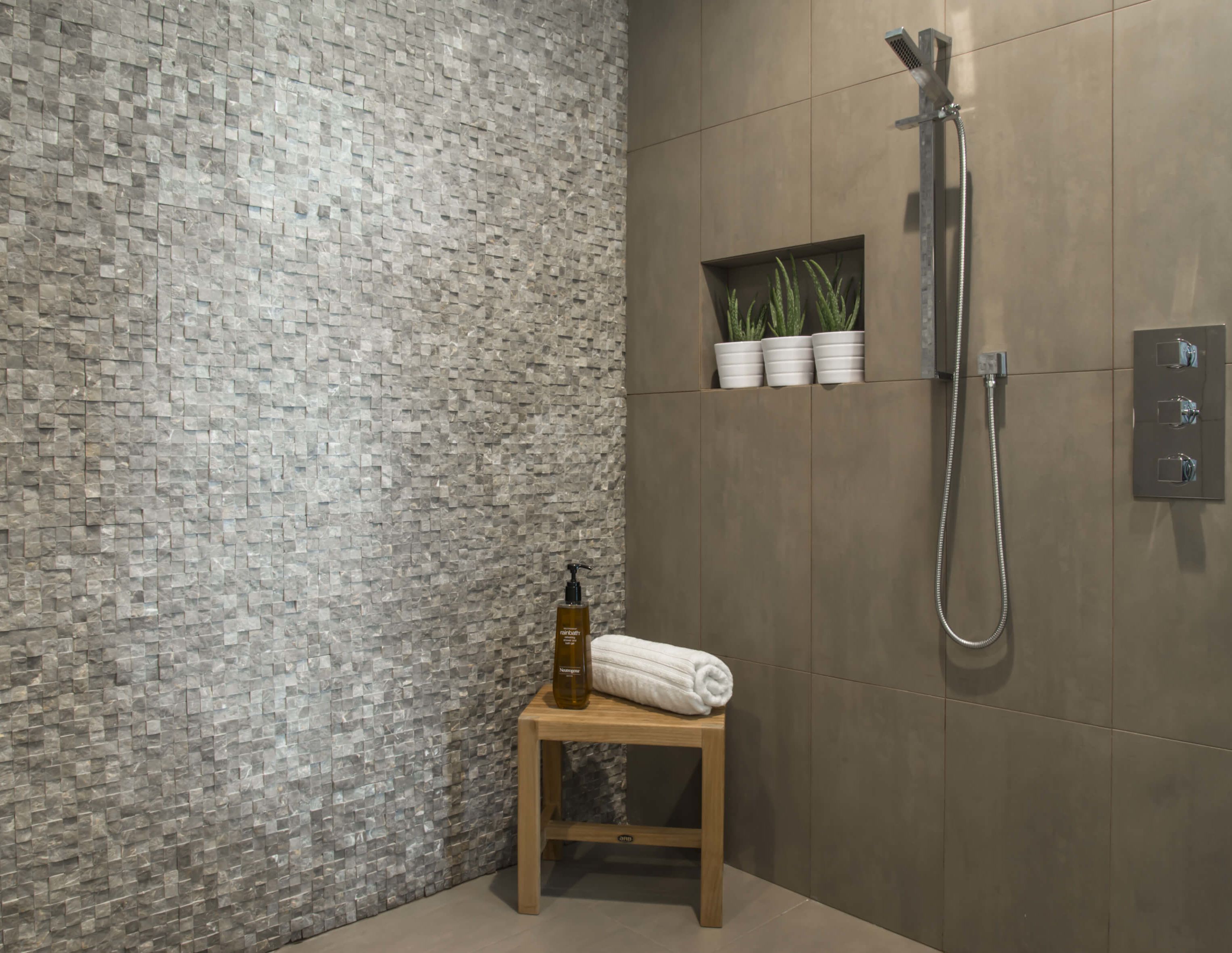 Spa like natural stone and porcelain stone shower designed by Cincinnati Interior Designer, RM Interiors.