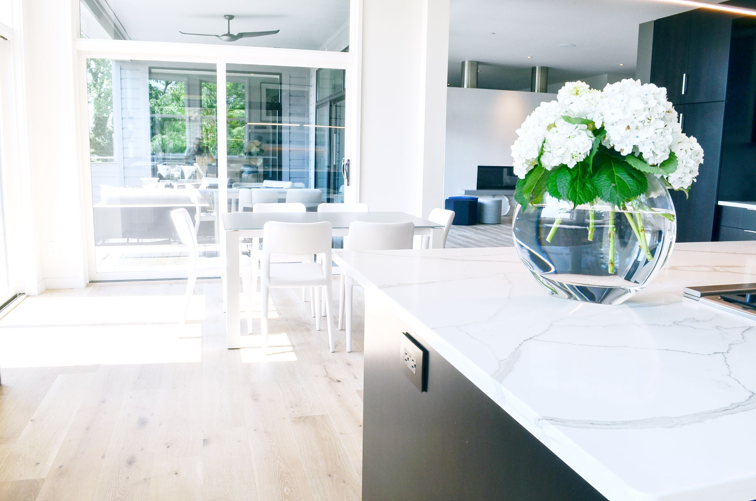 Minimal, modern, and clean white furnishings in a modern kitchen by interior designer, RM Interiors.