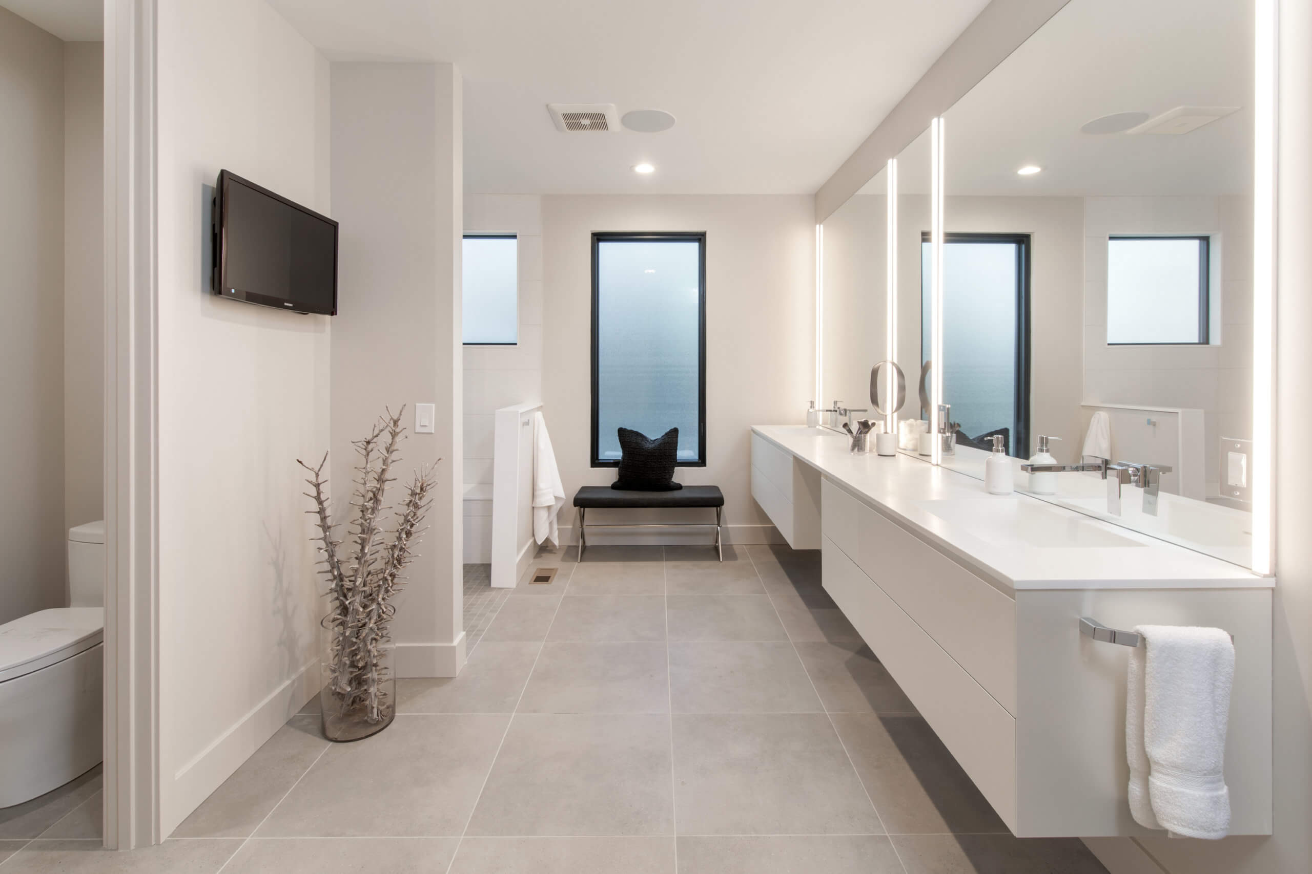 All white custom modern bathroom with custom white vanity. Bathroom designed by Cincinnati's premiere interior designer, Renan Menninger of RM Interiors.
