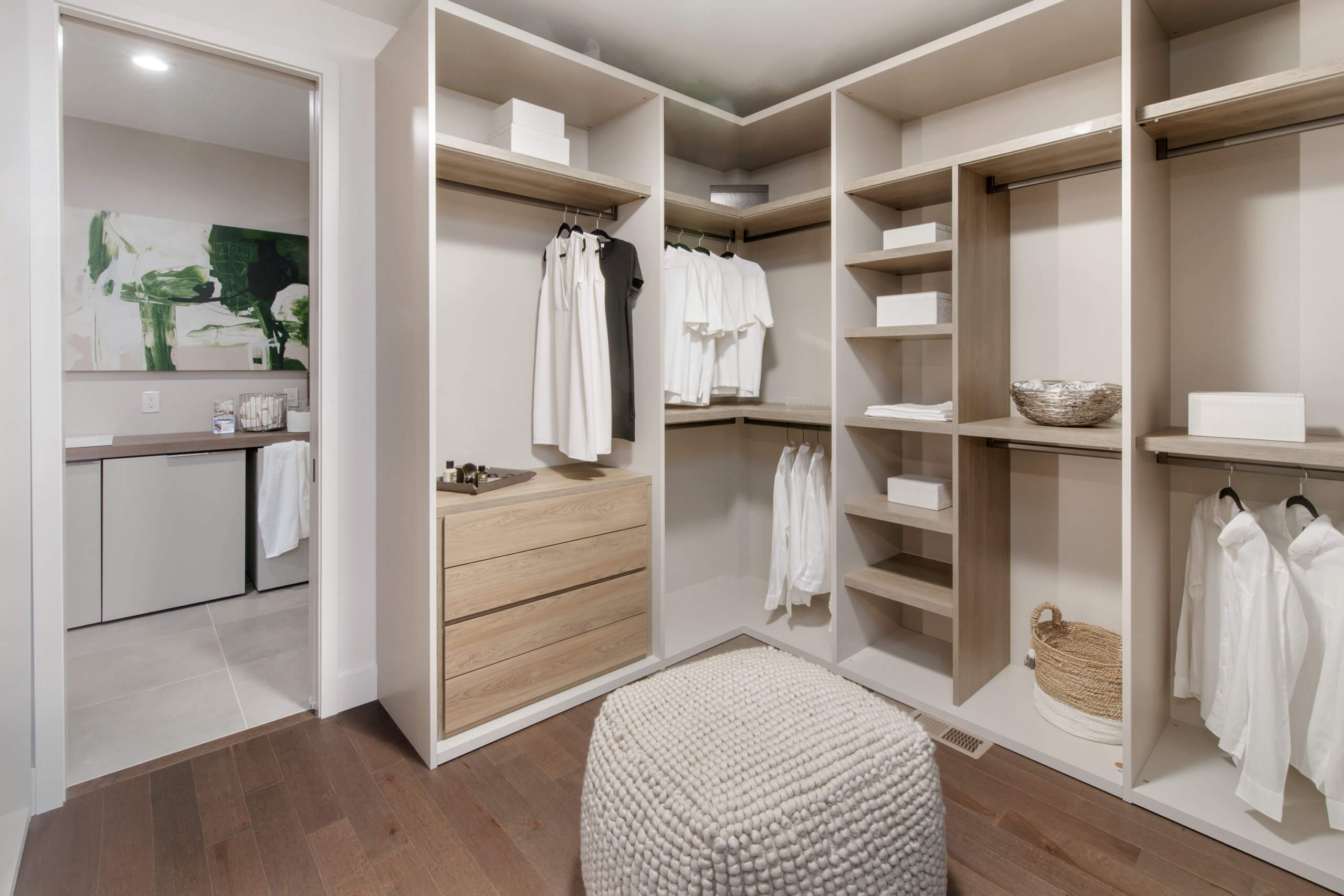 Custom walk-in closet featuring custom cabinetry by Pianca. Custom closed by interior designer RM Interiors.