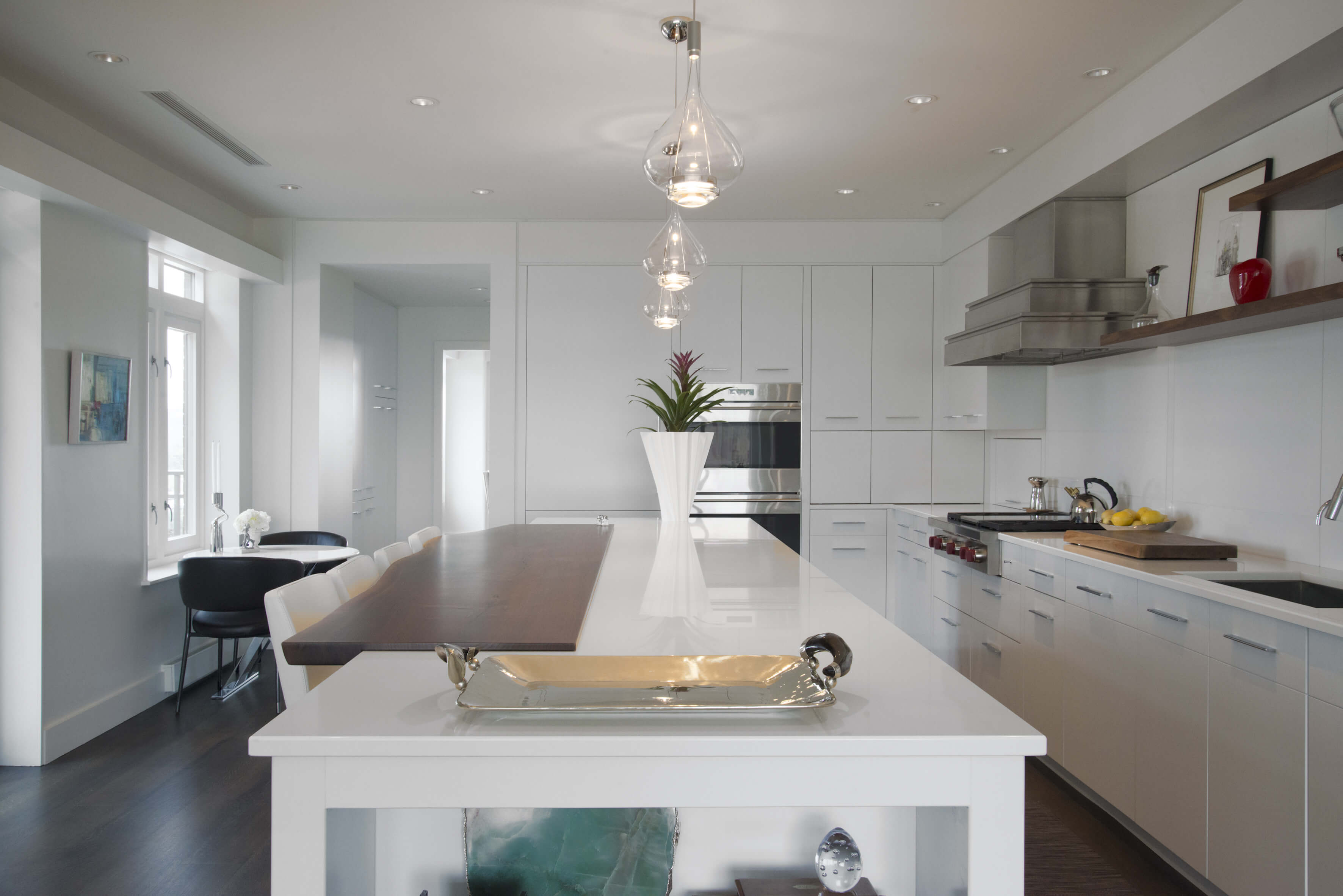 Contemporary white kitchen with embedded live-edge walnut into the kitchen island. Designed by Interior Designer, RM Interiors of Cincinnati, Oh.