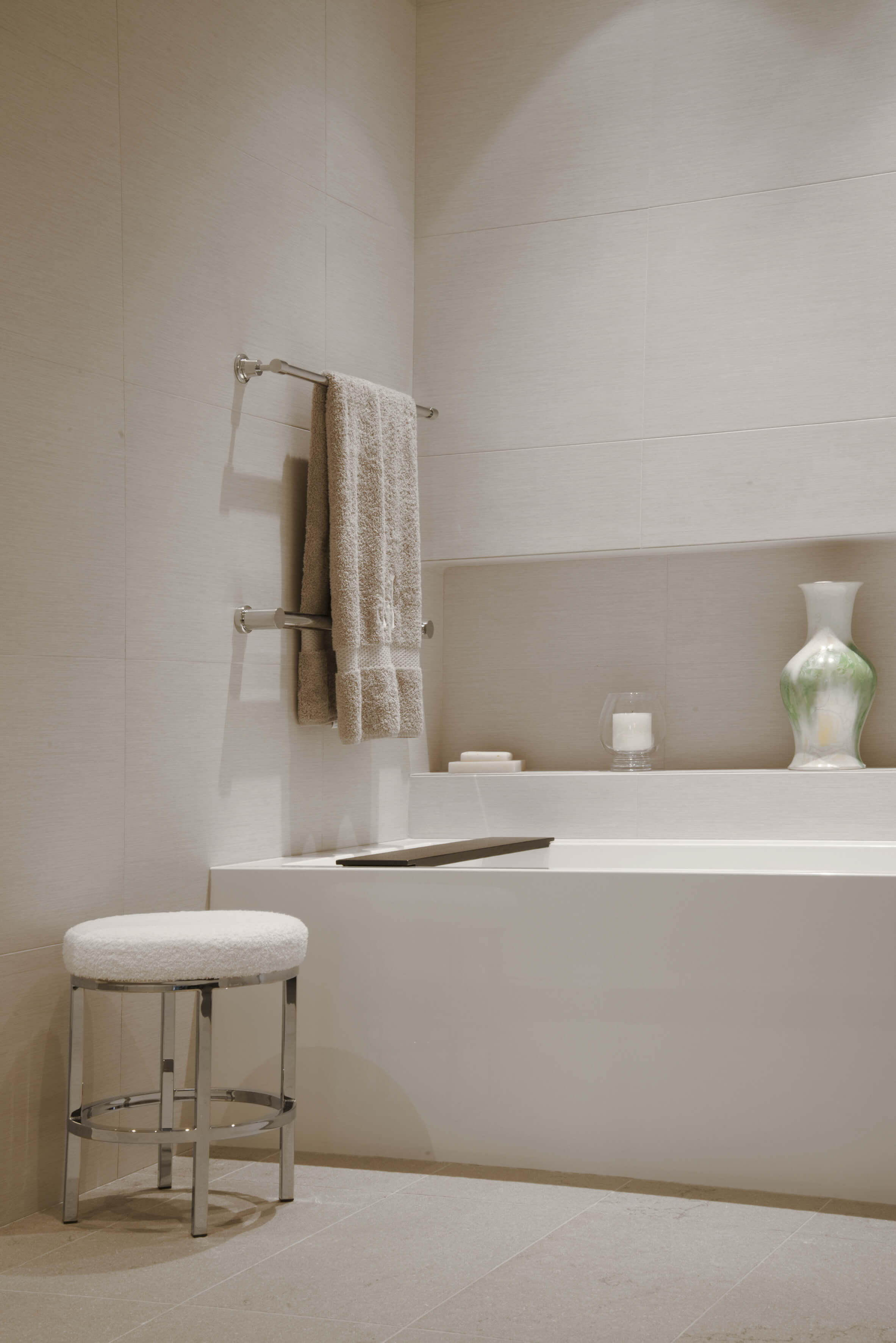 White natural stone bathroom creates calm. Designed by Interior Designer, RM Interiors of Cincinnati, OH.